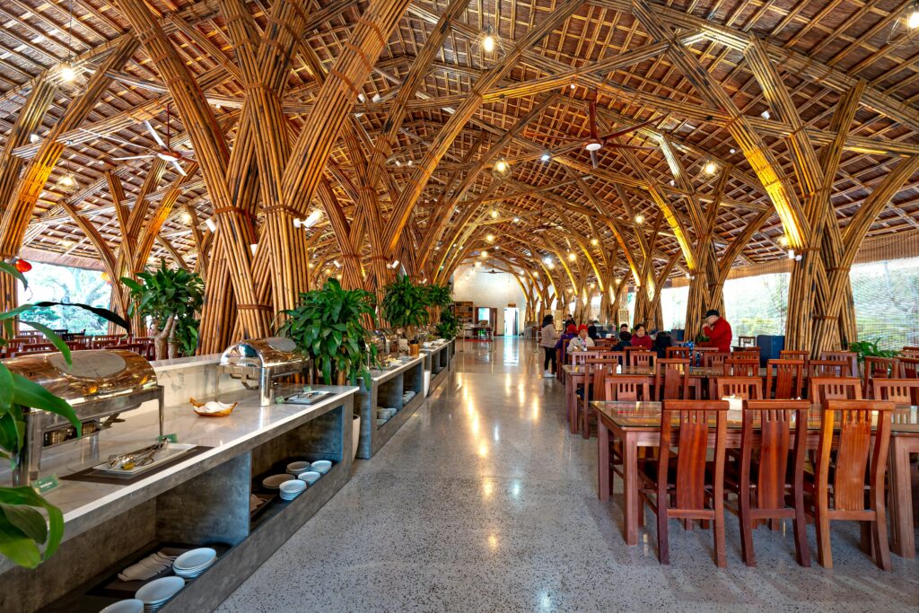 Stunning bamboo restaurant interior featuring elegant arches and wooden furniture with a modern buffet layout.