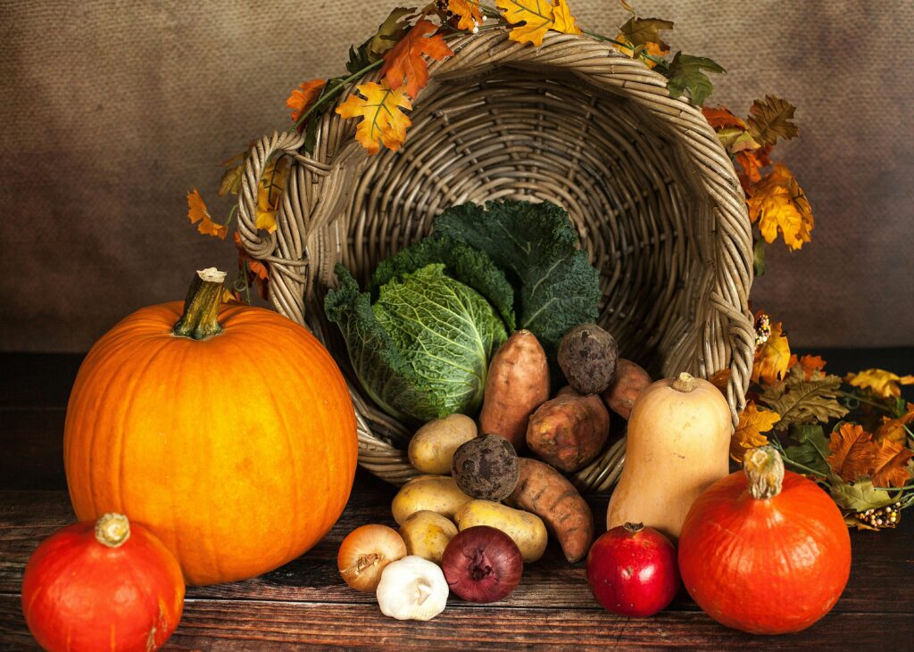 A rustic cornucopia overflowing with fresh autumn vegetables, symbolizing abundance and harvest.