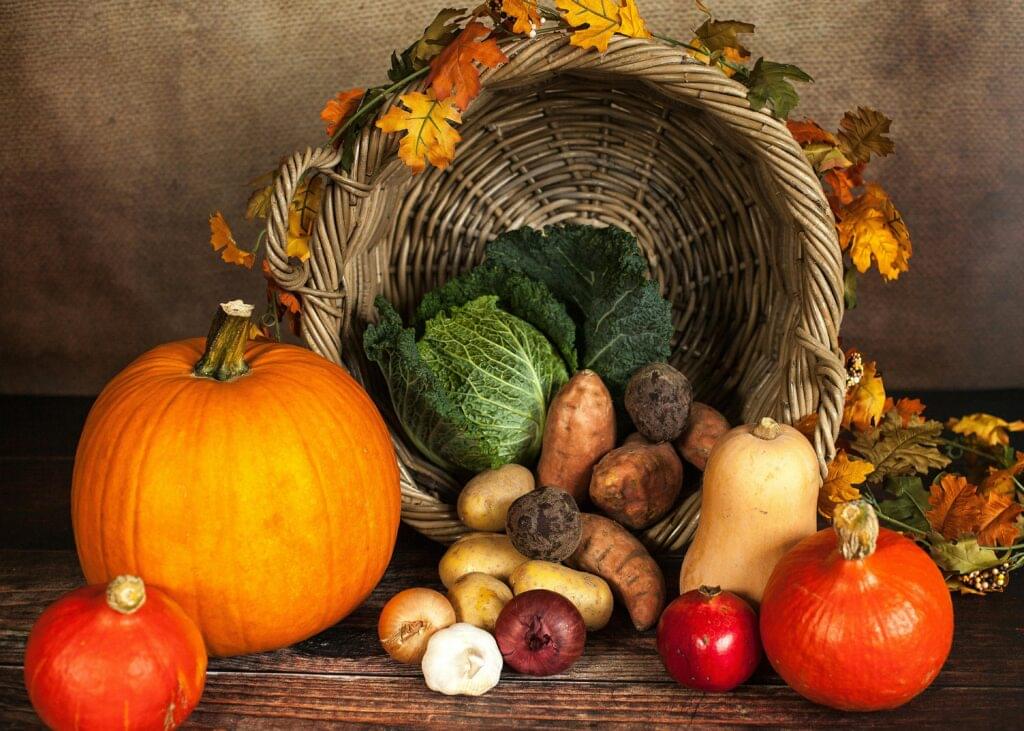A rustic cornucopia overflowing with fresh autumn vegetables, symbolizing abundance and harvest.